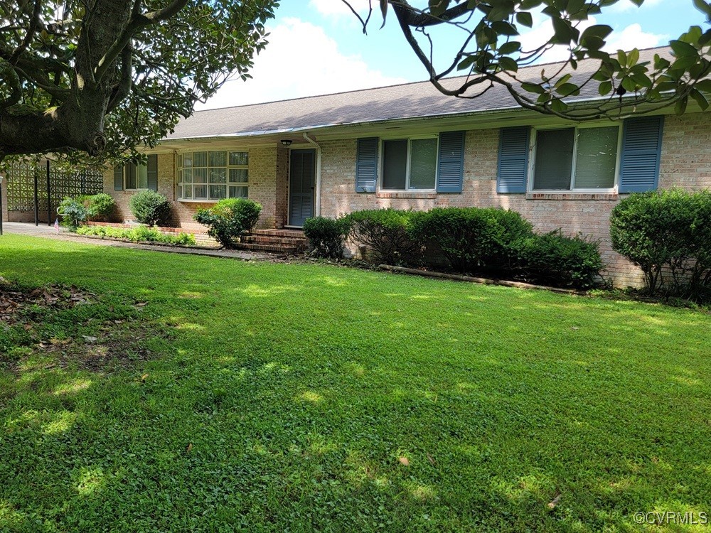 8241 Virginia Avenue West Point, VA 23181 - Photo 3 of 18 a front view of a house with garden