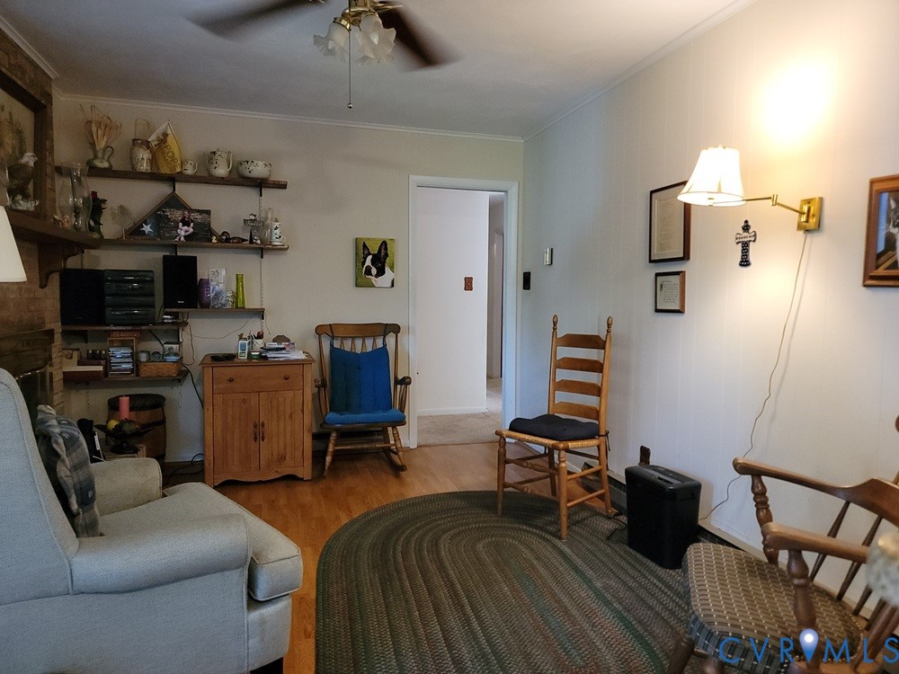 8241 Virginia Avenue West Point, VA 23181 - Photo 5 of 18 a bedroom with furniture and a wooden floor