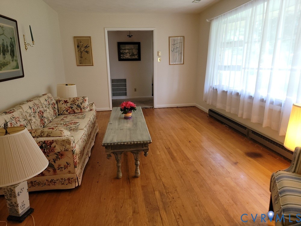 8241 Virginia Avenue West Point, VA 23181 - Photo 6 of 18 a living room with furniture and a wooden floor
