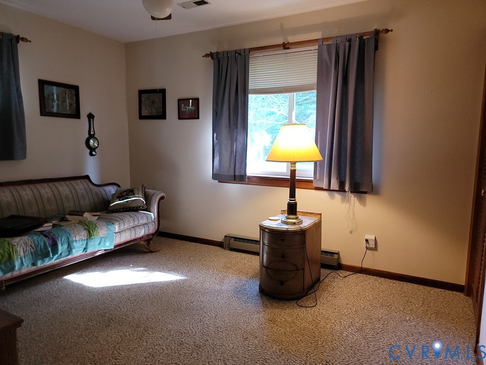 8241 Virginia Avenue West Point, VA 23181 - Photo 10 of 18 a living room with furniture and a lamp