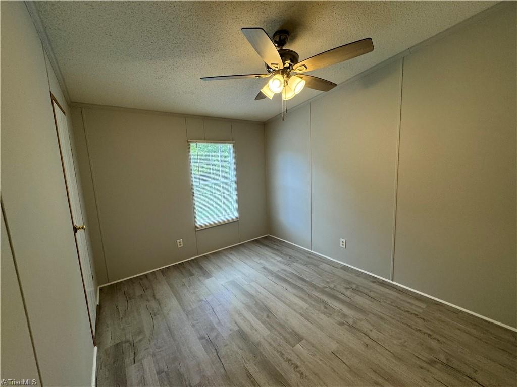 315 Marshall Farm Road Mount Airy, NC 27030 - Photo 42 of 50 3rd bedroom with new paint, blinds, flooring, and ceiling fan