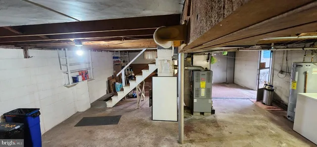 a view of water heater room with stairs