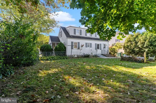 a view of house with backyard and garden