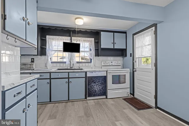 a kitchen with stainless steel appliances granite countertop a stove and cabinets