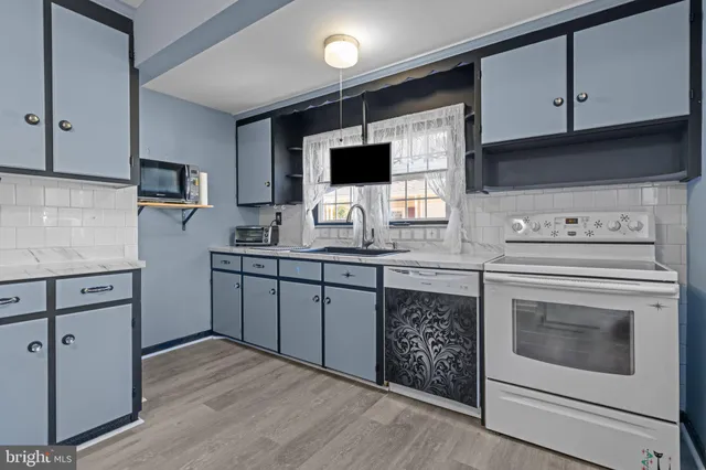 a kitchen with a sink stove and microwave