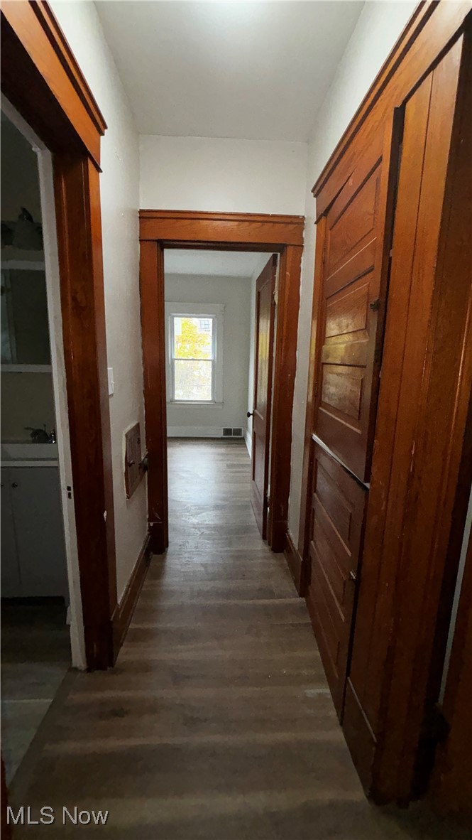 13421 Ashburton Road Cleveland, OH 44110 - Photo 22 of 28 Hallway featuring dark hardwood / wood-style flooring
