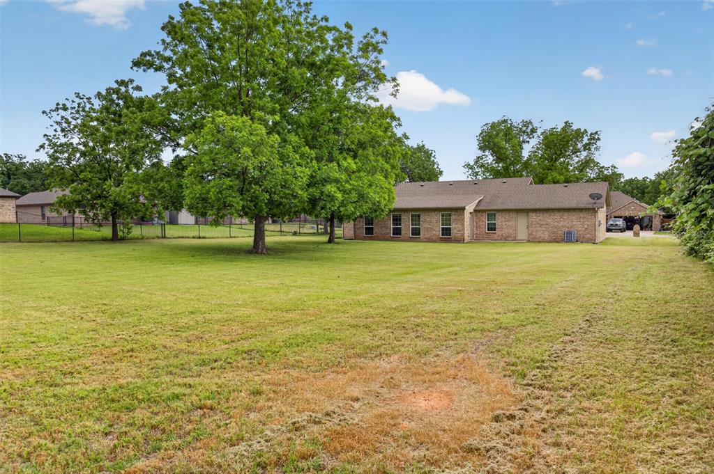 505 East 5th Street Springtown, TX 76082 - Photo 35 of 39 a view of a house with a yard