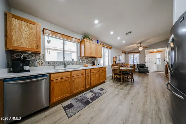 a kitchen with stainless steel appliances granite countertop sink stove top oven and cabinets