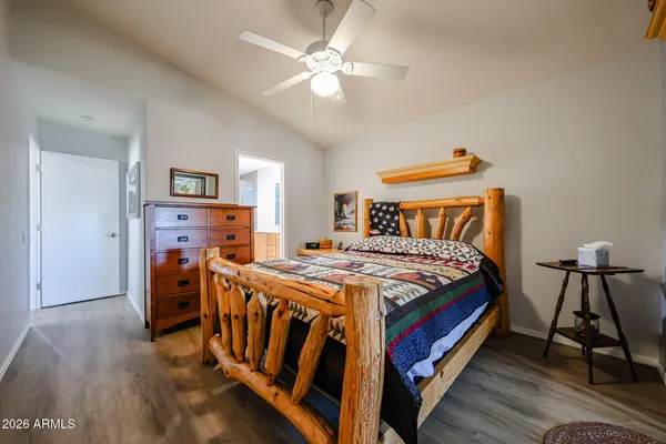 a bedroom with a bed and wooden floor