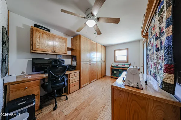 a very nice looking room with wooden floor and furniture