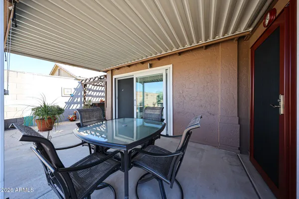 a patio with table and chairs