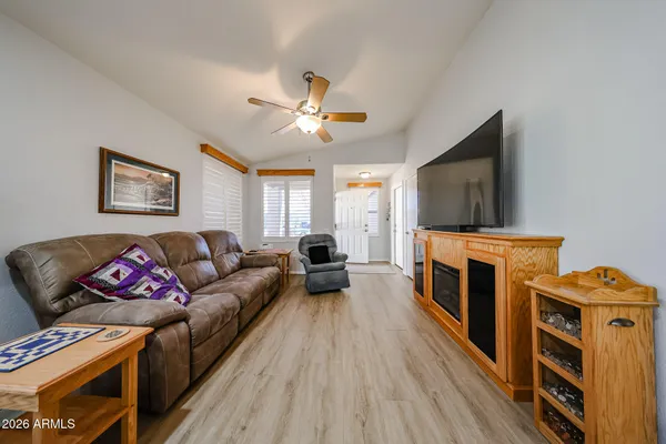 a living room with furniture a fireplace and a flat screen tv