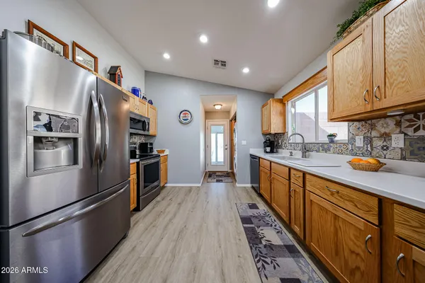 a kitchen with stainless steel appliances a refrigerator and a sink