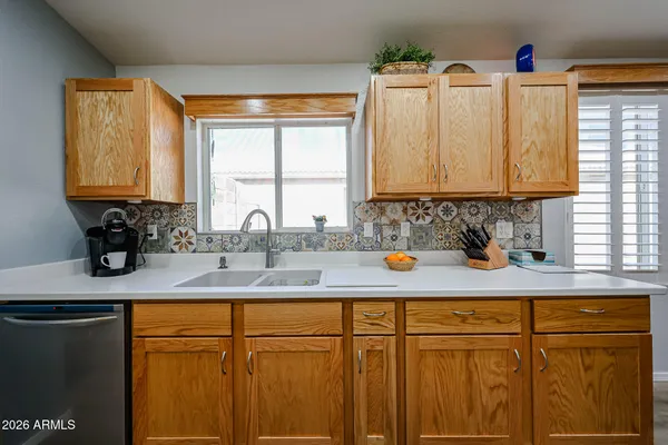 a kitchen with stainless steel appliances granite countertop a sink and a window