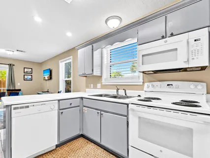 a kitchen with a sink stove and cabinets