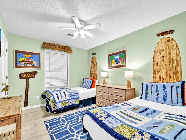 a living room with furniture and a baby crib