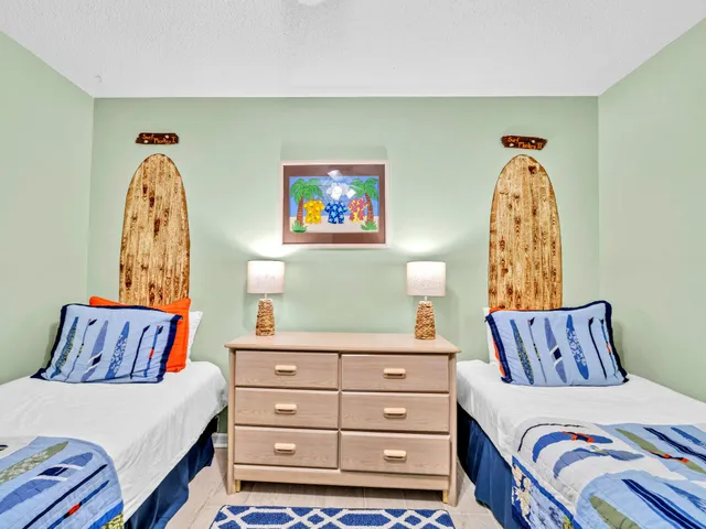 a bedroom with a bed and a painting on the wall