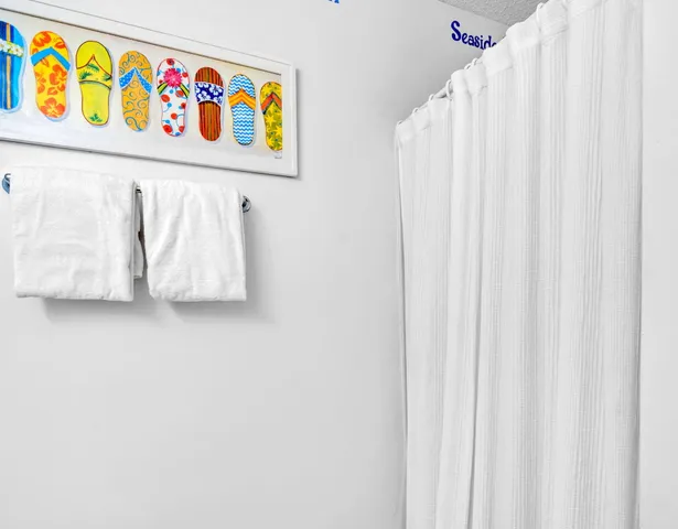 a white cabinet with a white curtain