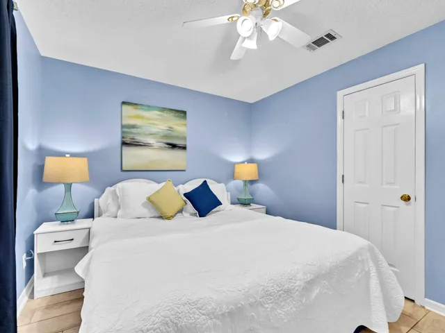 a bedroom with a bed and a lamp