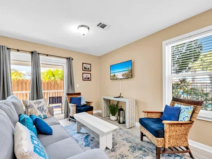 a living room with furniture and a floor to ceiling window