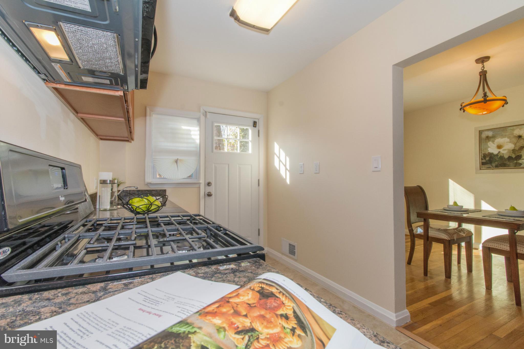 604 Brisbane Road Baltimore, MD 21229 - Photo 11 of 30 a kitchen with a stove and a microwave