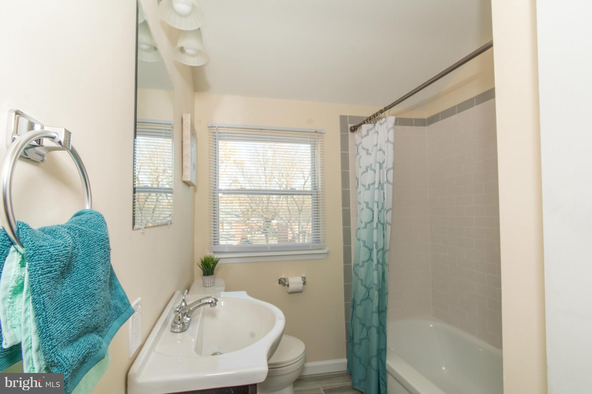 604 Brisbane Road Baltimore, MD 21229 - Photo 14 of 30 a bathroom with a sink toilet and shower