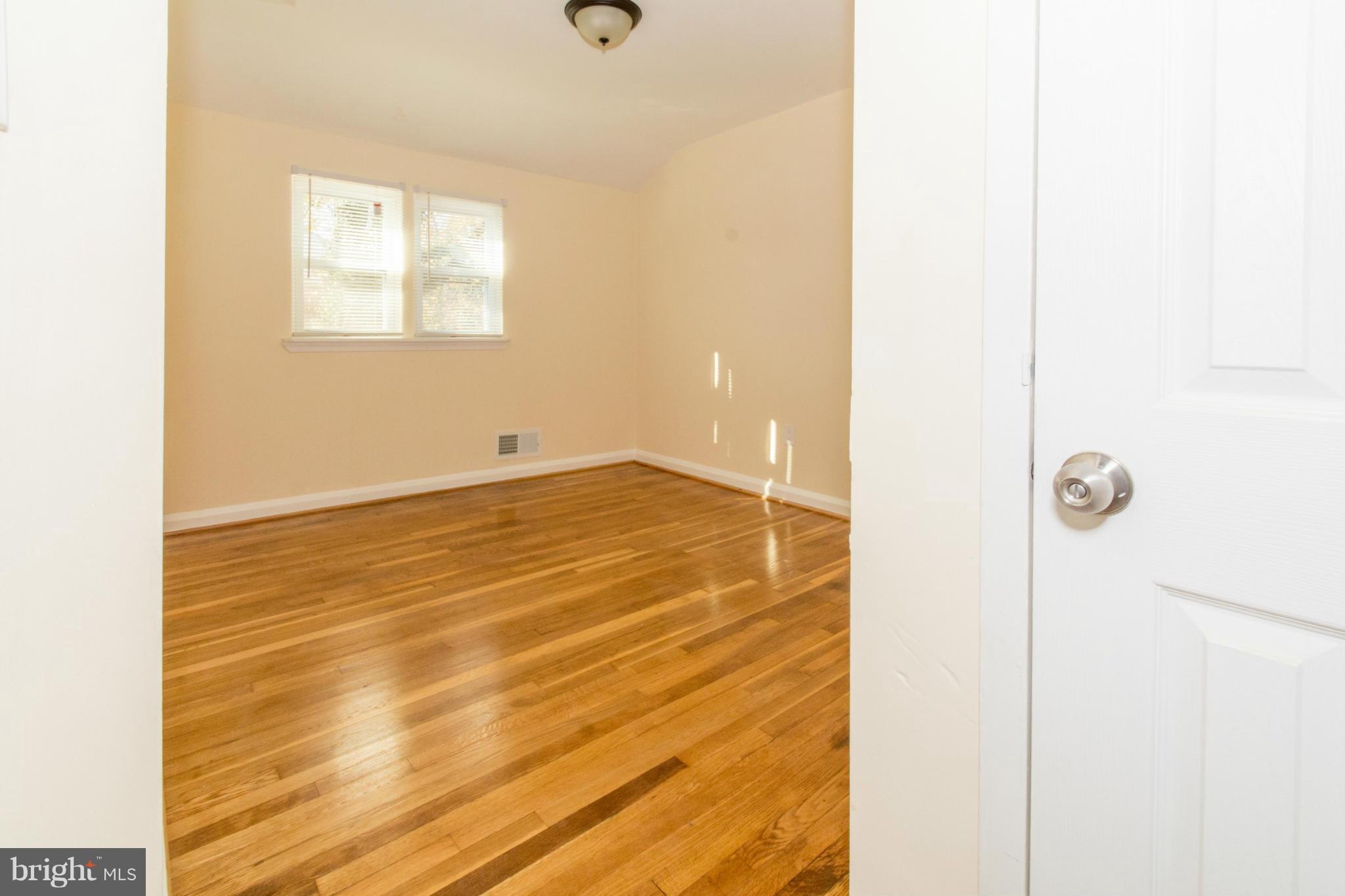 604 Brisbane Road Baltimore, MD 21229 - Photo 21 of 30 a view of an empty room with wooden floor