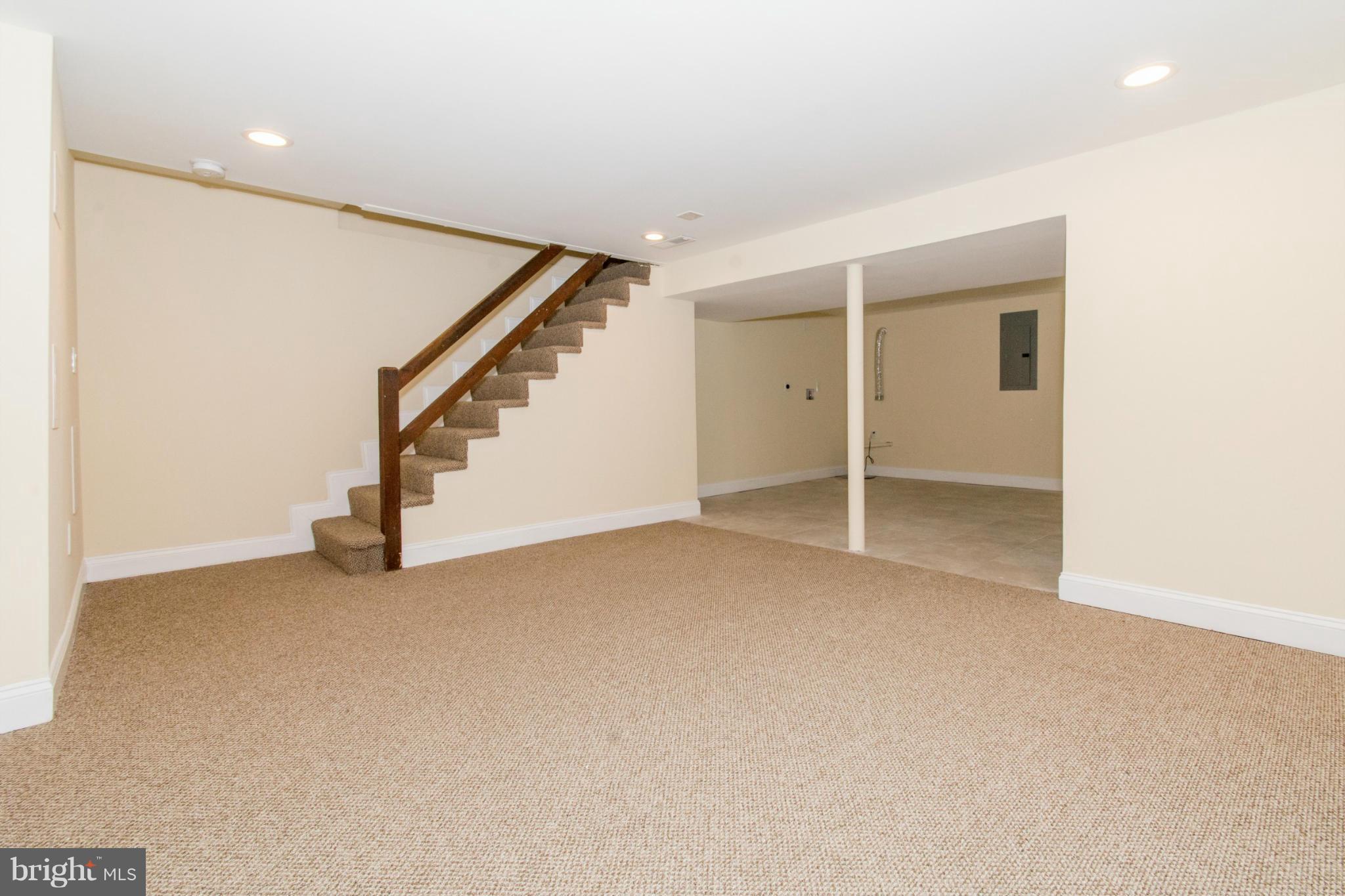 604 Brisbane Road Baltimore, MD 21229 - Photo 27 of 30 an empty room with stairs and white walls