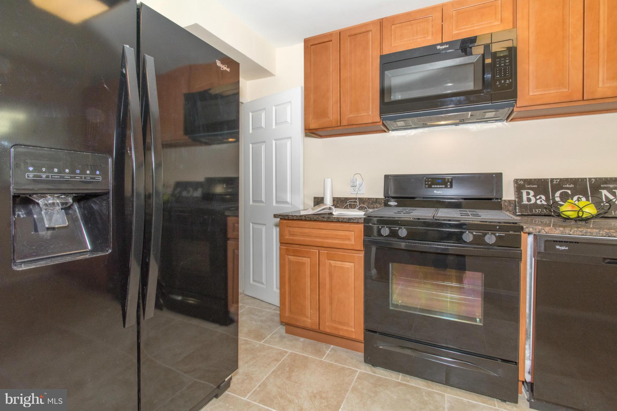 604 Brisbane Road Baltimore, MD 21229 - Photo 10 of 30 a kitchen with stainless steel appliances granite countertop a stove and a microwave