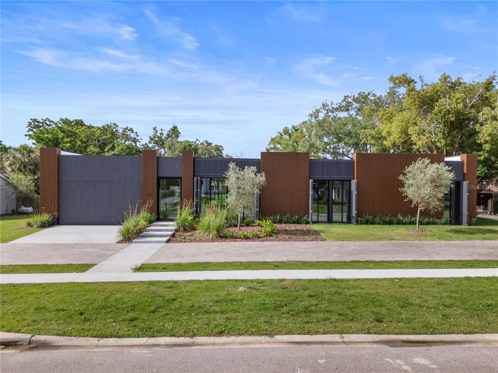 8966 Easterling Drive Orlando, FL 32819 - Photo 2 of 12 a backyard of a house with table and chairs