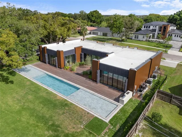 an aerial view of a house with a big yard