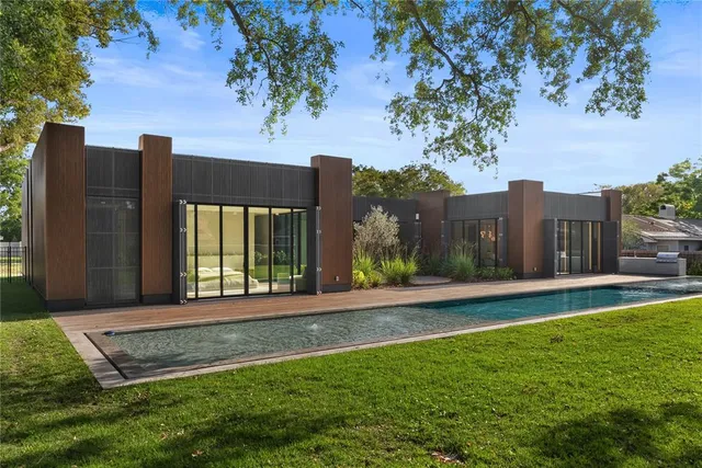 a view of a house with a yard and a tree