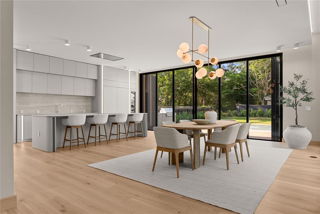 8966 Easterling Drive Orlando, FL 32819 - Photo 6 of 12 a dining room with wooden floor a chandelier a glass table and chairs