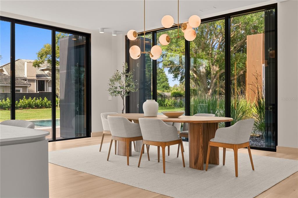 8966 Easterling Drive Orlando, FL 32819 - Photo 7 of 12 a view of a dining room with furniture window and outside view