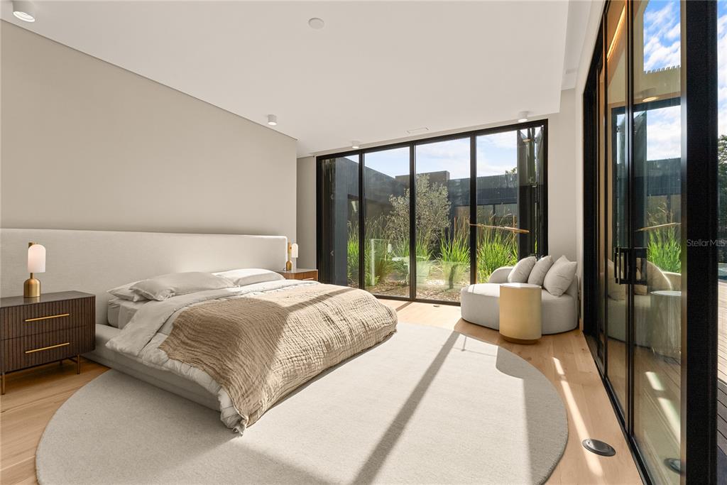 8966 Easterling Drive Orlando, FL 32819 - Photo 8 of 12 a bedroom with a bed and a large window