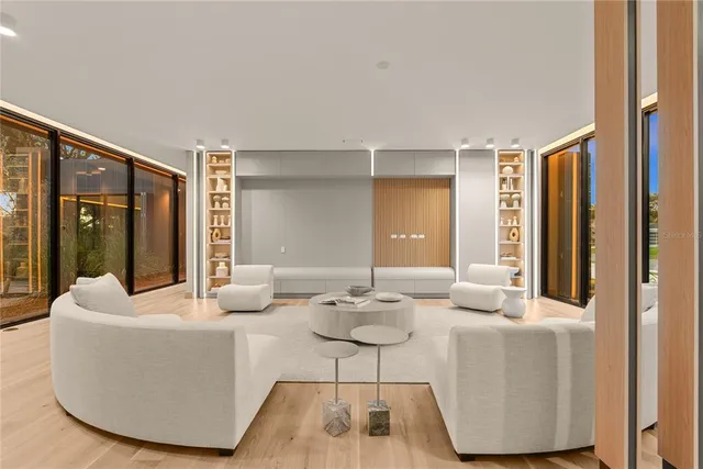 a living room with furniture and a floor to ceiling window