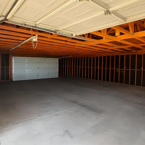 a view of garage and wooden fence