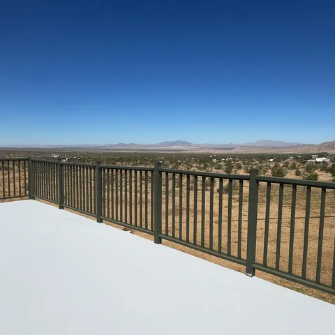 an empty room with windows and ceiling fan