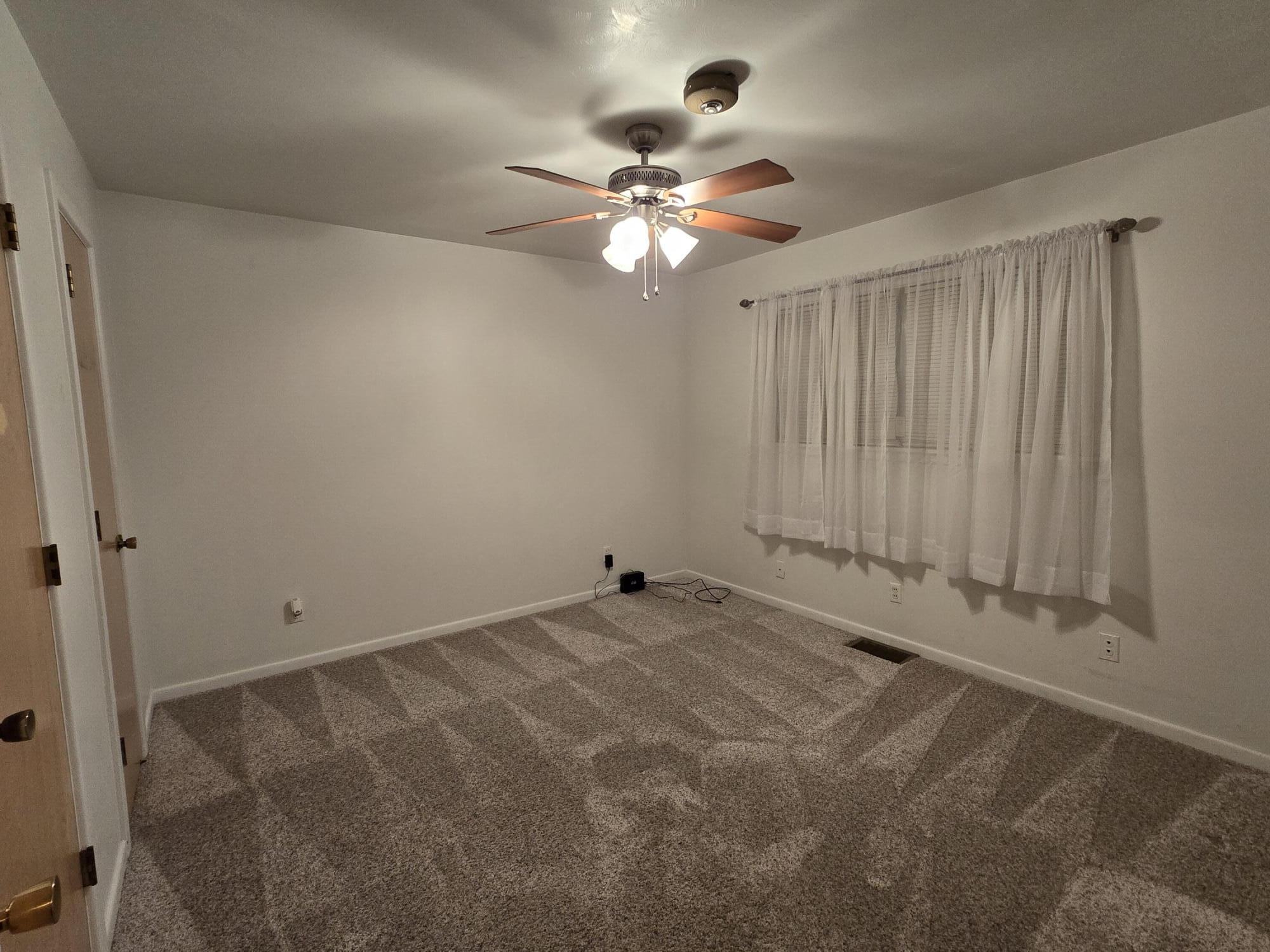 2229 South 6th Street Lamesa, TX 79331 - Photo 16 of 27 a view of a room with window and ceiling fan