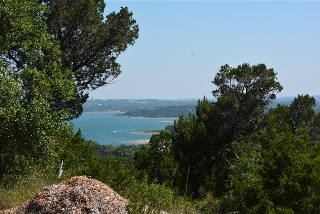 9208 Ranchland Hills Boulevard Jonestown, TX 78645 - Photo 1 of 1 a view of a lake with a mountain in the background