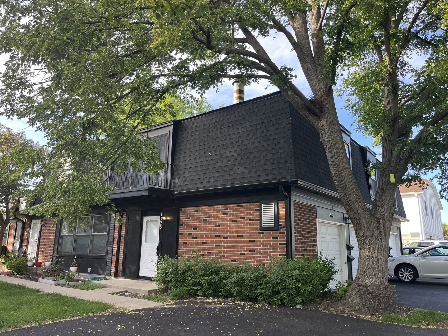 1326 Inverrary Lane, Unit 1326 Deerfield, IL 60015 - Photo 1 of 15 a front view of a house with garden