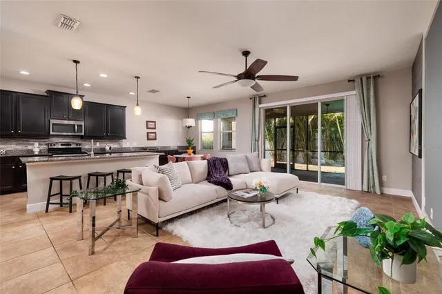 a living room kitchen with furniture and a large window