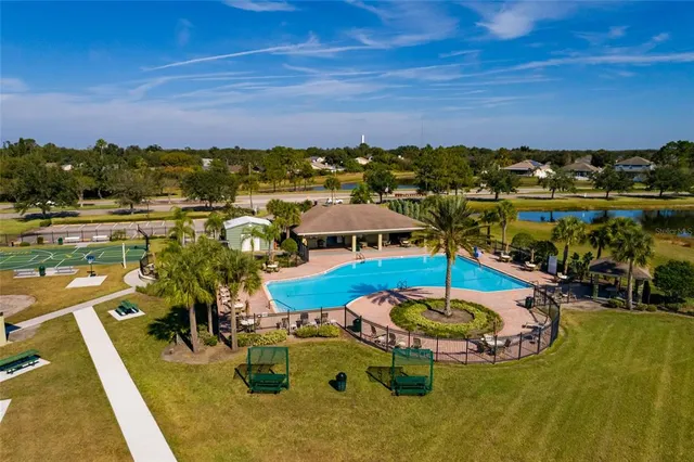 a bathroom with a granite countertop sink toilet a mirror and shower