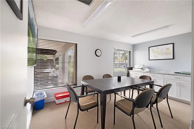 a view of a dining room with furniture and window