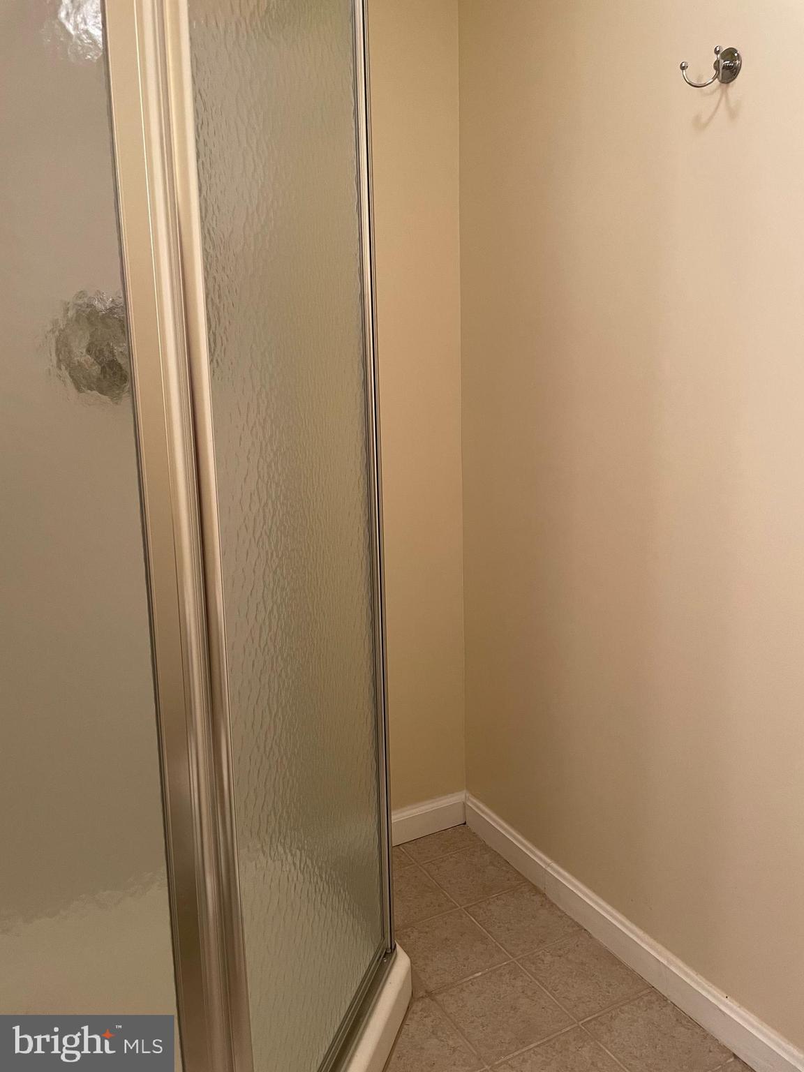 12405 Gooderham Way Gaithersburg, MD 20878 - Photo 28 of 31 a bathroom with a glass door