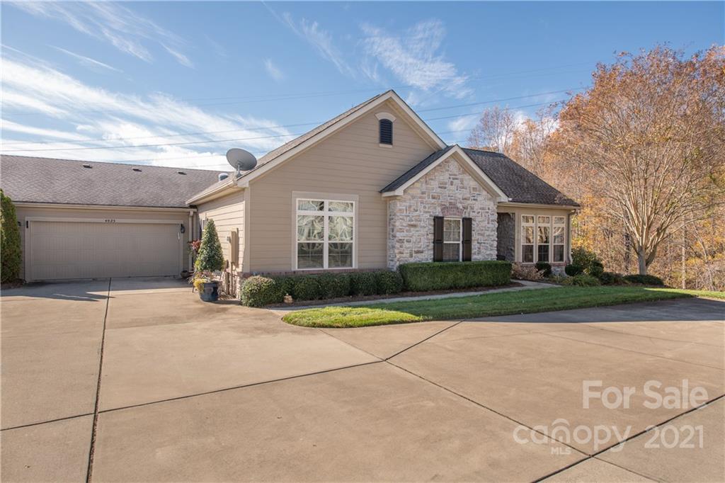 4825 Polo Gate Boulevard Charlotte, NC 28216 - Photo 2 of 30 a front view of a house with a yard and garage