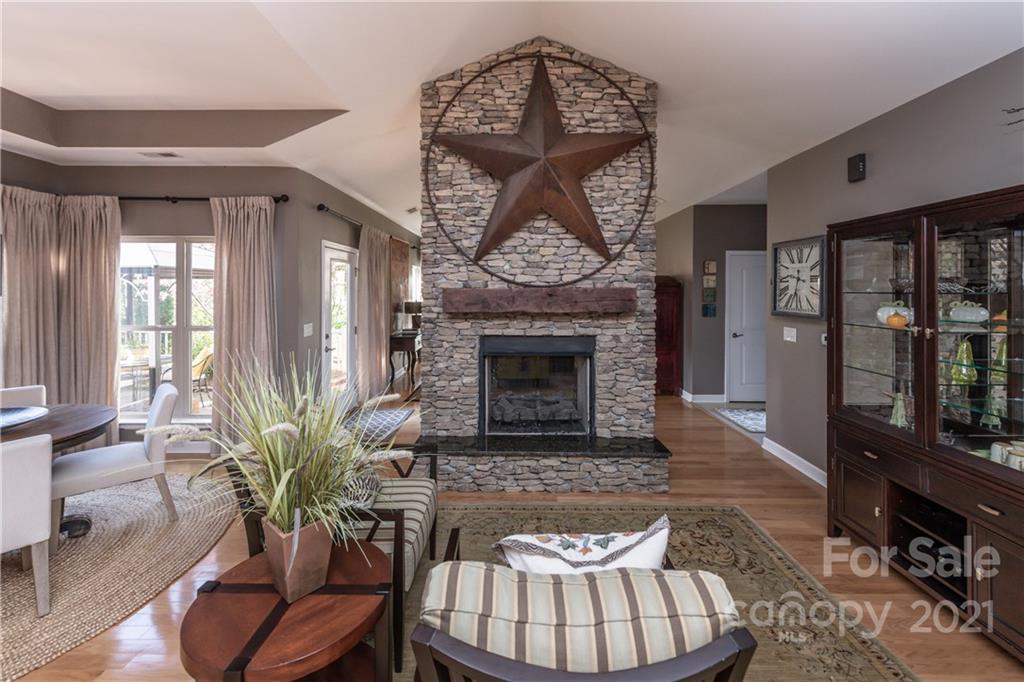4825 Polo Gate Boulevard Charlotte, NC 28216 - Photo 13 of 30 a living room with furniture a fireplace and a potted plant