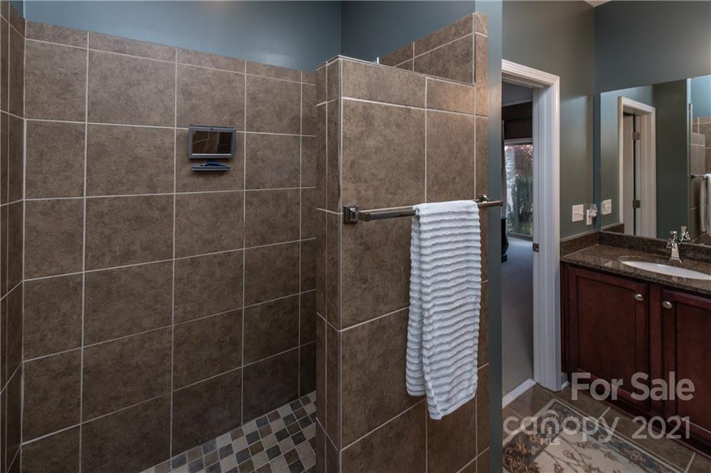 4825 Polo Gate Boulevard Charlotte, NC 28216 - Photo 20 of 30 a bathroom with a walk in closet and wooden floor