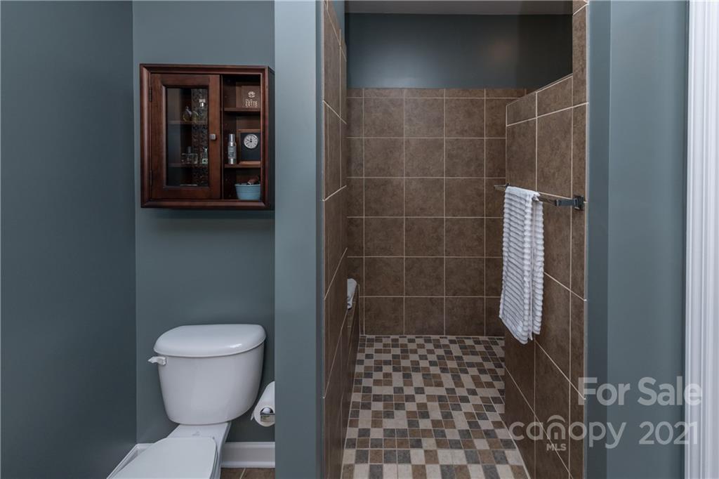 4825 Polo Gate Boulevard Charlotte, NC 28216 - Photo 21 of 30 a bathroom with a toilet and a shower