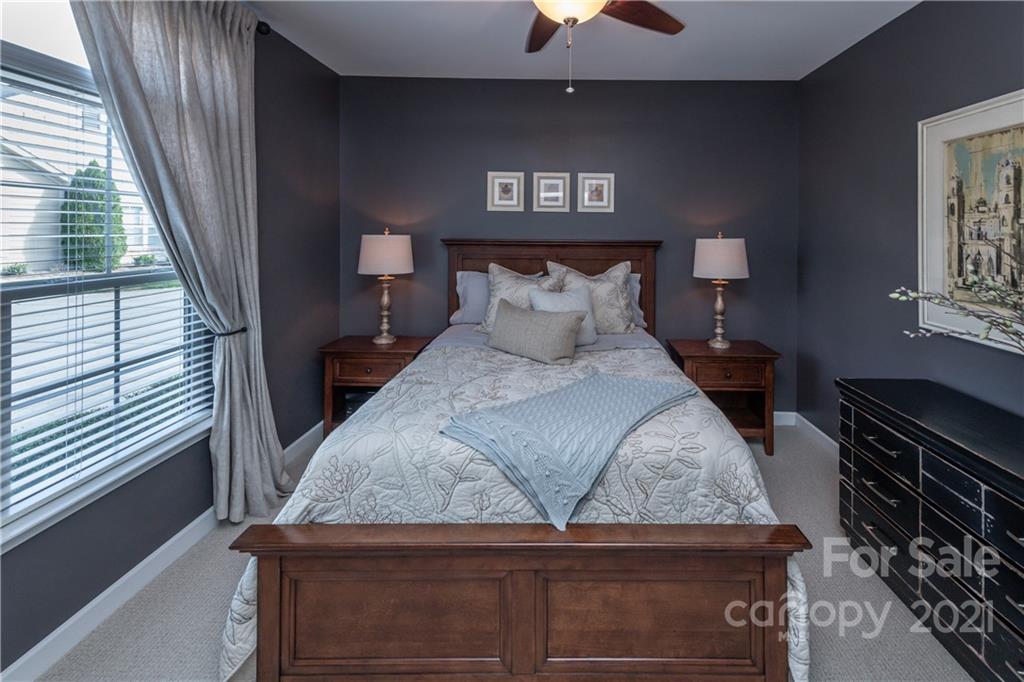 4825 Polo Gate Boulevard Charlotte, NC 28216 - Photo 22 of 30 a bed sitting in a bedroom next to a window